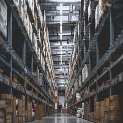 image of warehouse with shelves and boxes disappearing into th e horizon